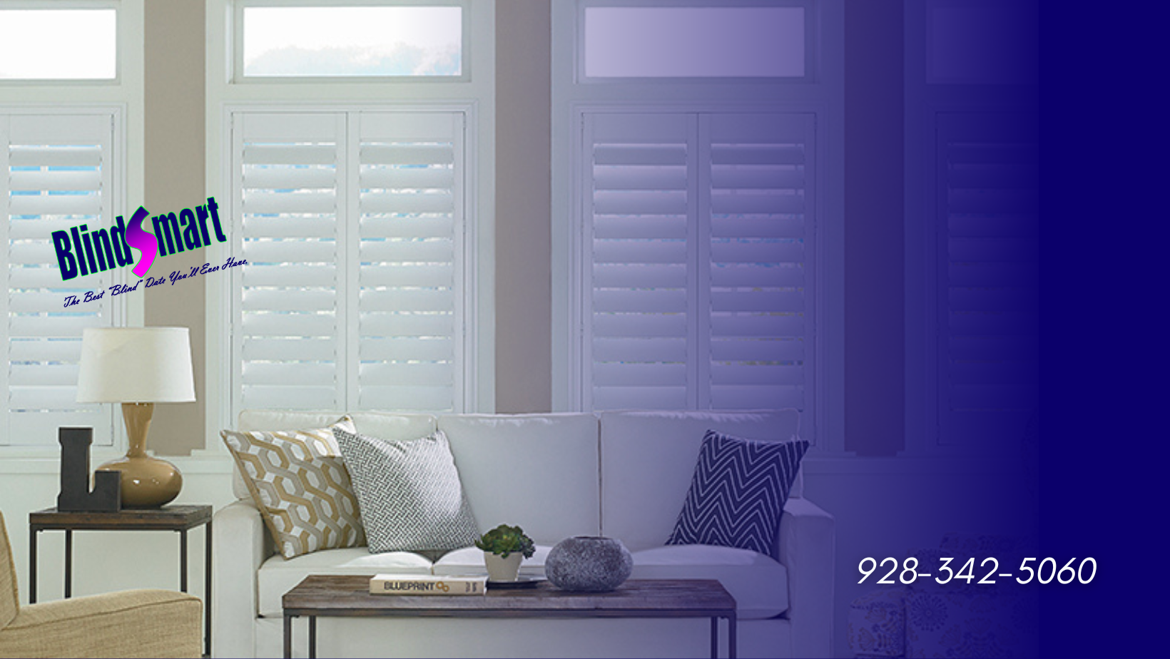 A well-lit, modern living room interior showcasing custom-fitted, white plantation shutters. The scene features a plush white sofa with decorative pillows (geometric patterns), a minimalist wooden coffee table with a small planter and book, and a side table with a decorative lamp. Large windows with the plantation shutters are visible on the left and center. A distinct dark blue and purple gradient overlay fades from right to left, framing the image. The Blindsmart logo and contact phone number are prominently displayed, showcasing the brand.